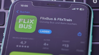 Ein Handy, das auf einem Tisch liegt und die FlixBus & Flixtrain App anzeigend